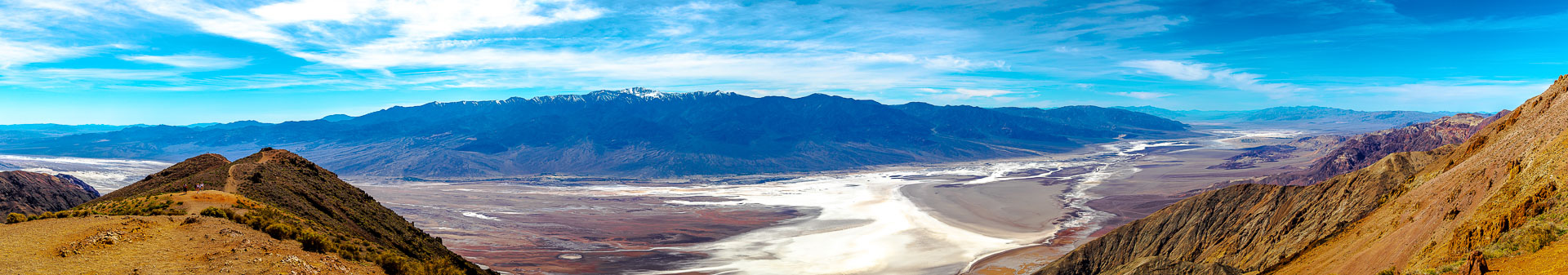 Death Valley dusk — long shadows stretch across the salt pan as the sun drops behind the Panamint Range